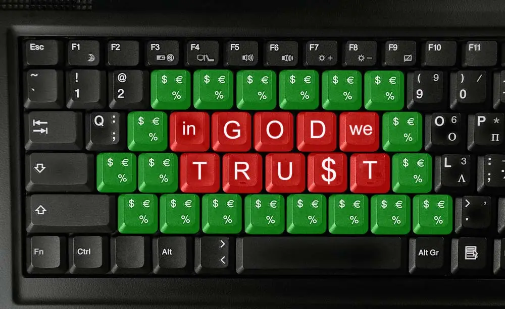 Keyboard with red and green keys and in God we trust in white lettering