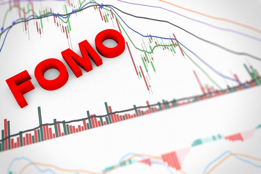 A 3D graphic showing the word FOMO and various trading graphs.